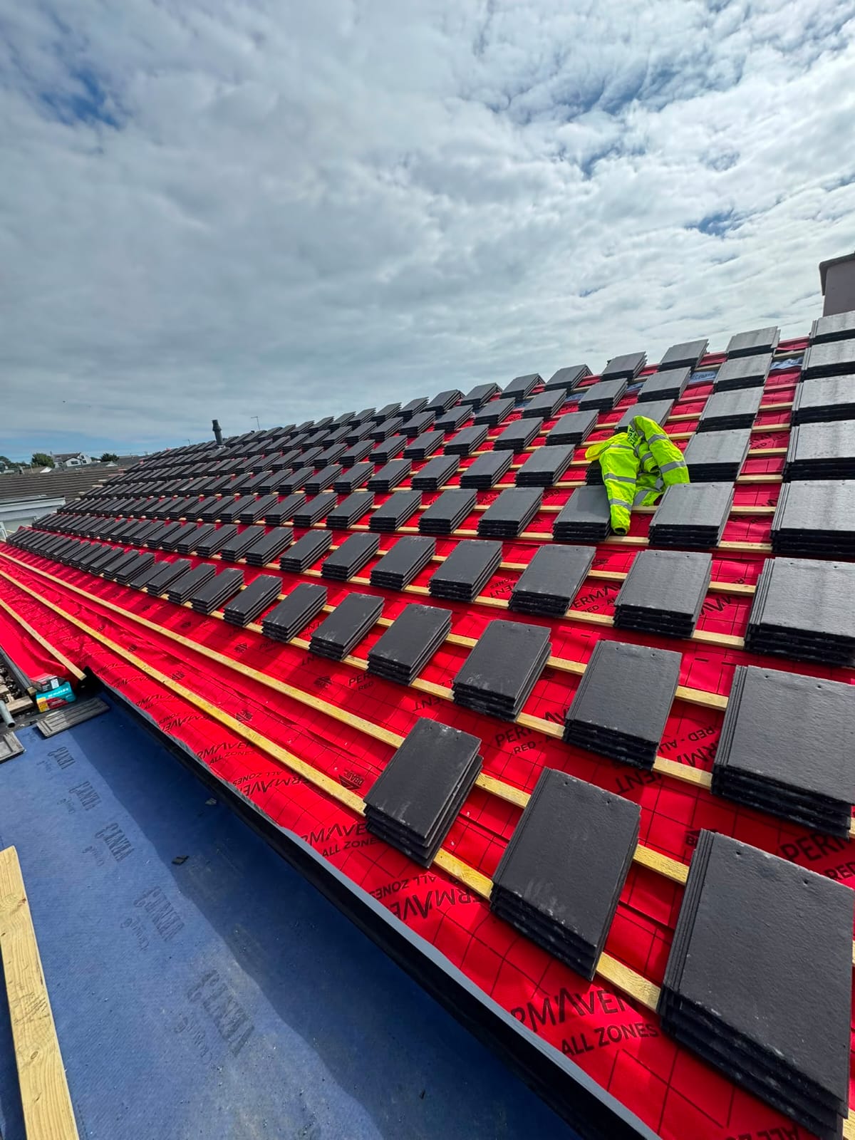 Roof rebuild with new battens, breather membrane and tiles being laid