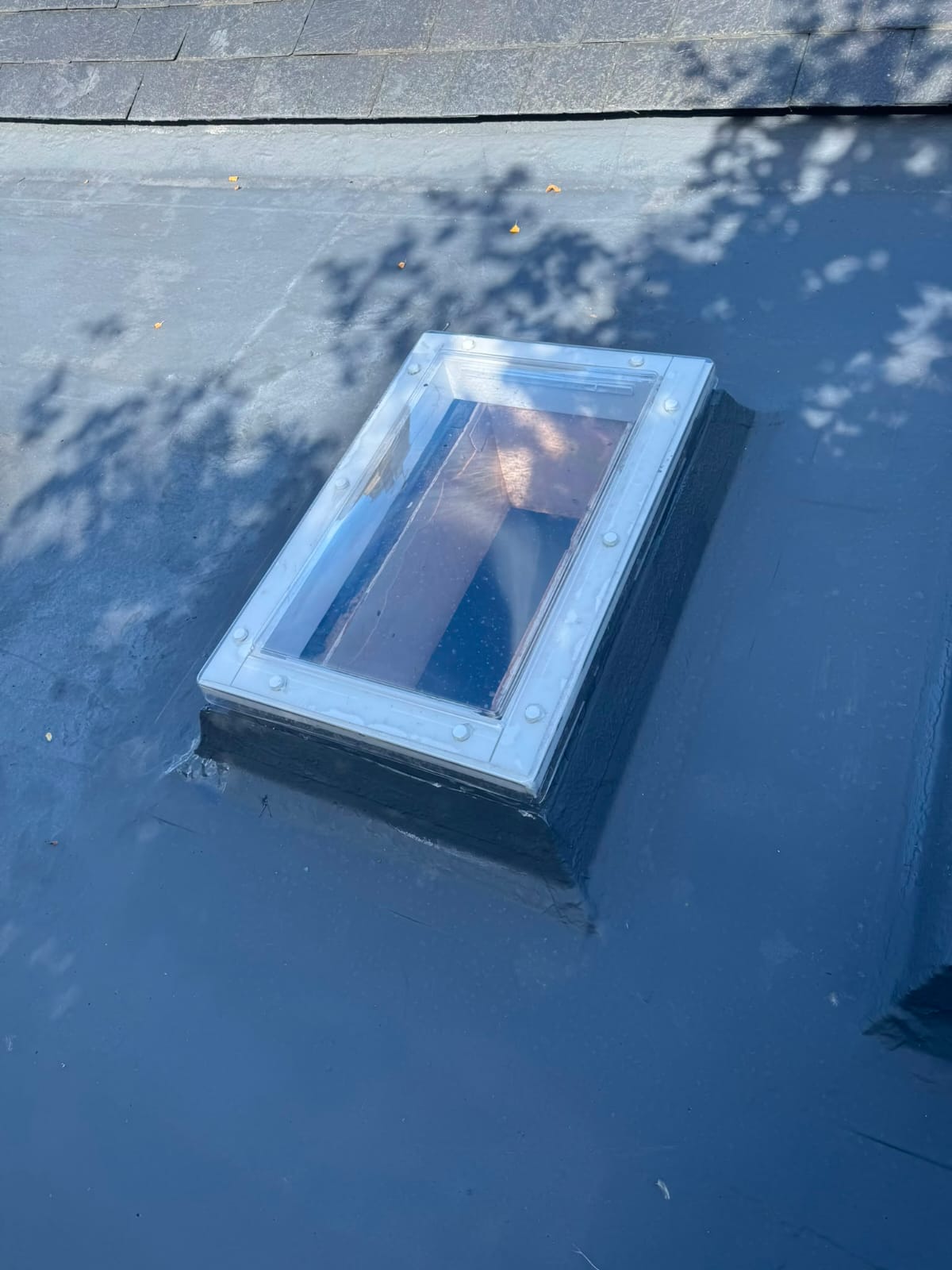 Velux skylight installation weathered neatly into a new roof covering
